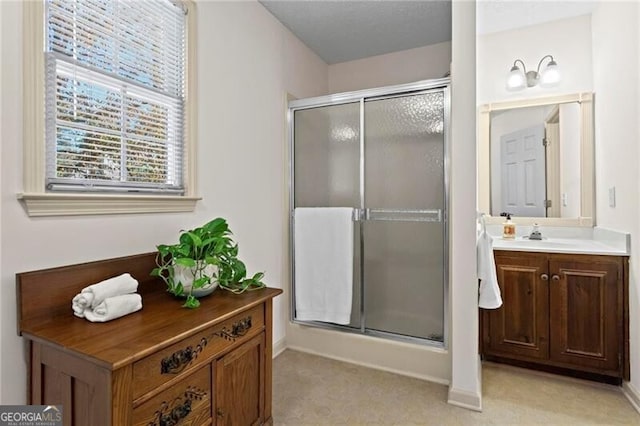 bathroom with vanity and a shower with shower door