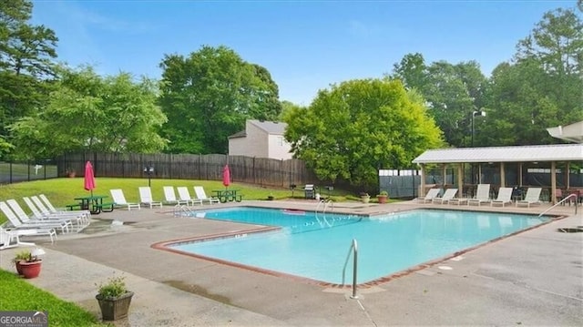 view of swimming pool with a patio area and a yard