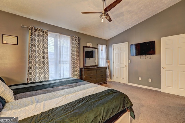 bedroom featuring a textured ceiling, ceiling fan, carpet floors, and lofted ceiling