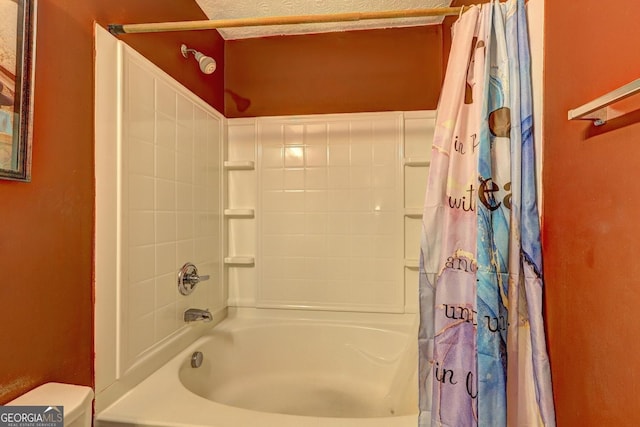 bathroom featuring toilet, a textured ceiling, and shower / tub combo