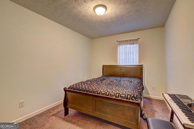 bedroom with carpet and a textured ceiling