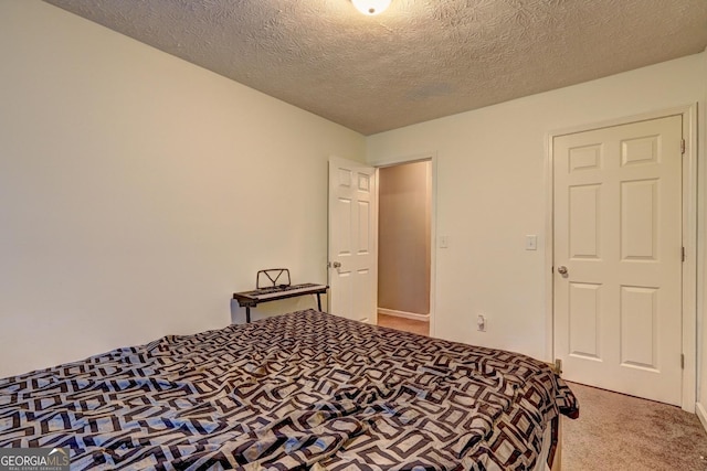 bedroom with carpet flooring and a textured ceiling