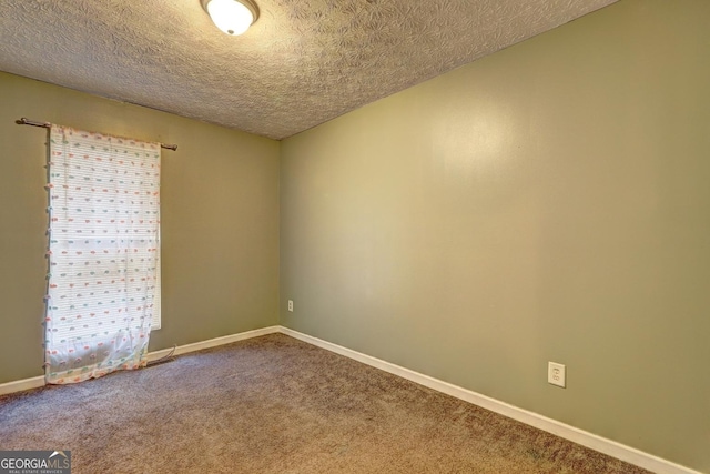 carpeted empty room with a textured ceiling