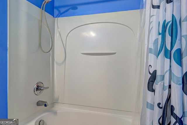 bathroom with shower / bath combo with shower curtain