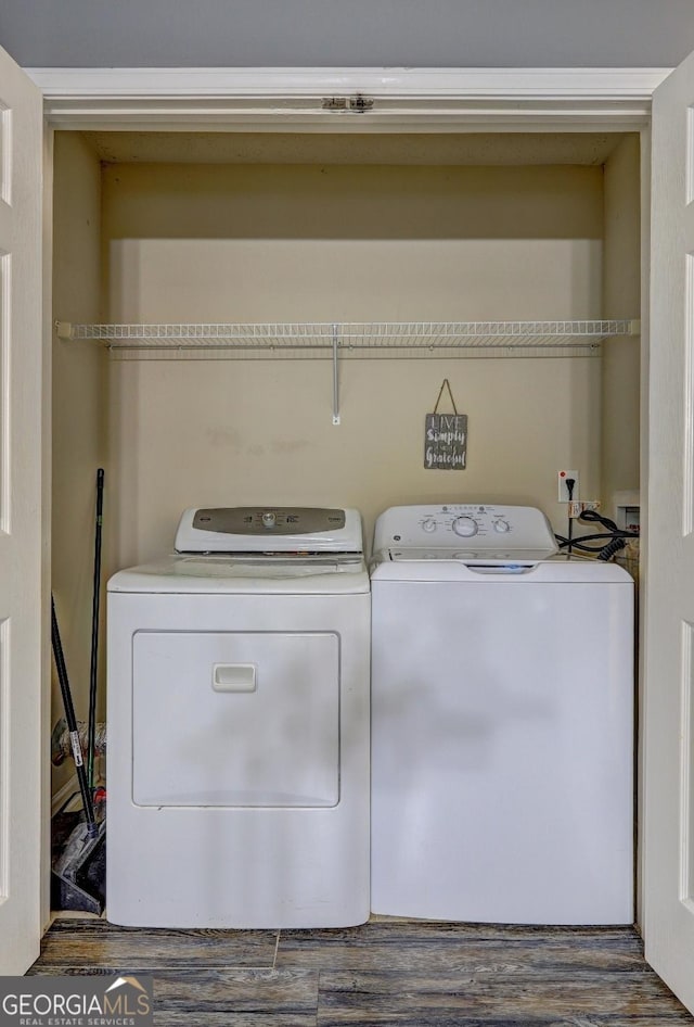 laundry room featuring washer and clothes dryer and dark wood-type flooring