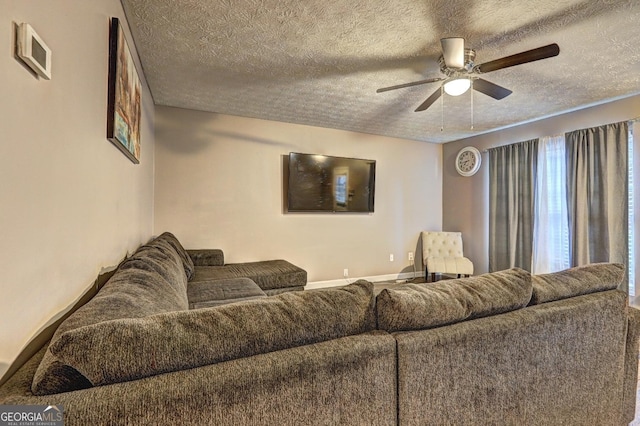 living room featuring a textured ceiling and ceiling fan