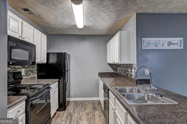 kitchen with black appliances, sink, decorative backsplash, dark hardwood / wood-style flooring, and white cabinetry