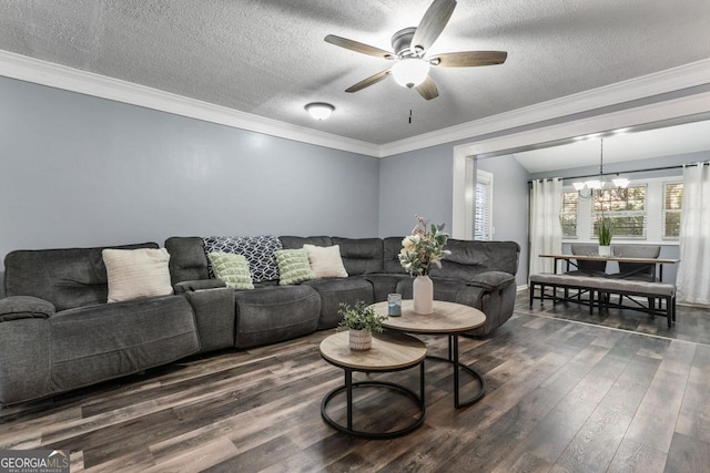 living room featuring ceiling fan with notable chandelier, dark hardwood / wood-style flooring, a textured ceiling, and ornamental molding