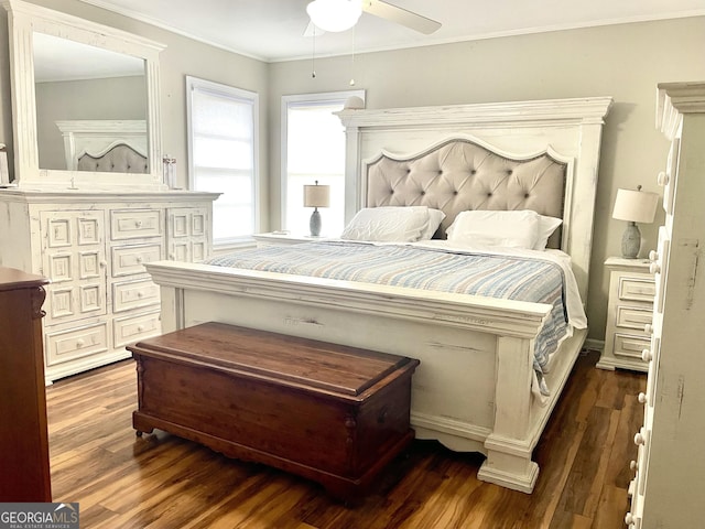 bedroom featuring dark hardwood / wood-style floors, ceiling fan, and ornamental molding