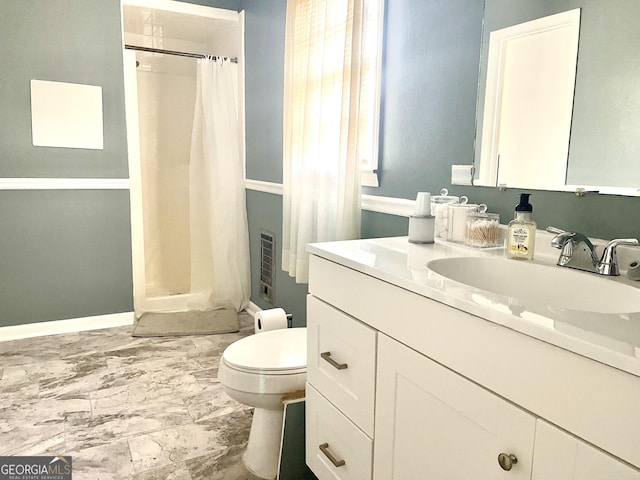 bathroom featuring toilet, vanity, and walk in shower