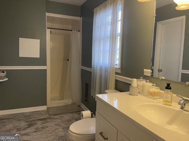 bathroom with vanity, curtained shower, and toilet