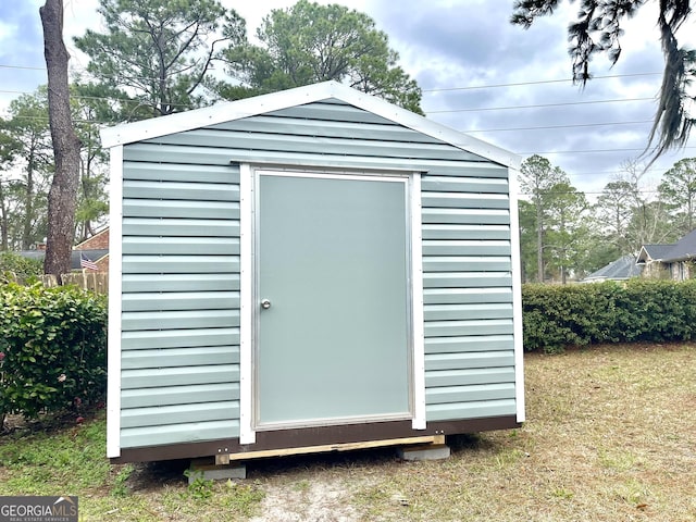 view of outbuilding with a lawn