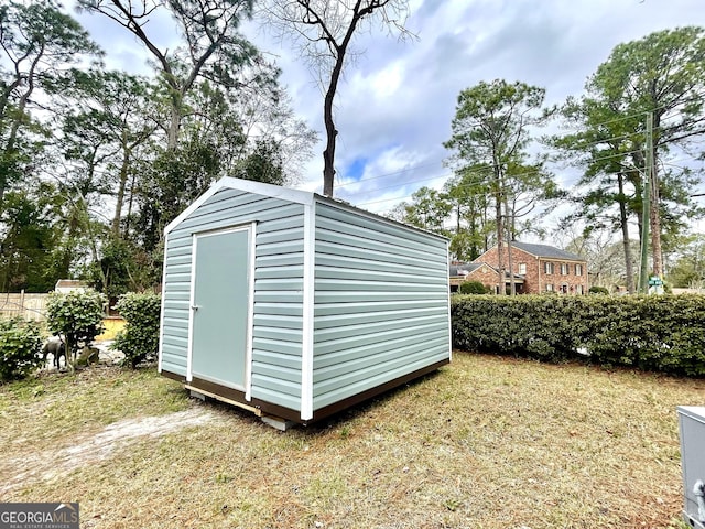 view of outdoor structure featuring a lawn