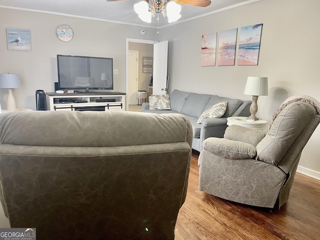 living room featuring hardwood / wood-style flooring, ceiling fan, and ornamental molding