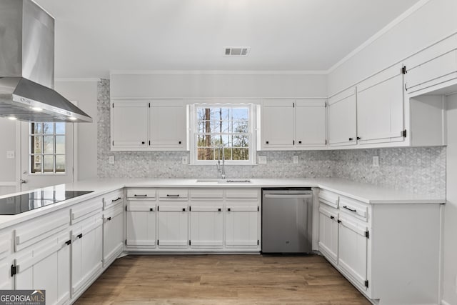 kitchen featuring white cabinets, wall chimney exhaust hood, black electric cooktop, sink, and dishwasher