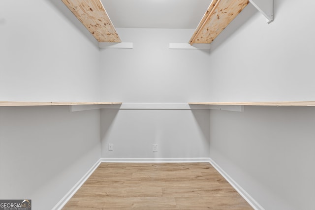 walk in closet featuring light hardwood / wood-style flooring