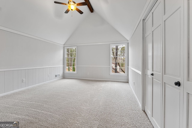 additional living space with vaulted ceiling with beams, ceiling fan, and light carpet