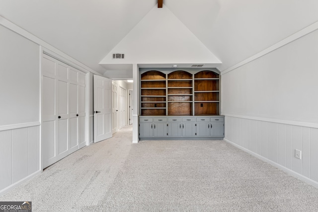 unfurnished bedroom with vaulted ceiling with beams, carpet floors, and a closet