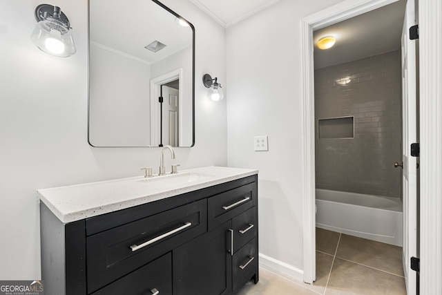 bathroom with vanity, tile patterned floors, tiled shower / bath, and ornamental molding