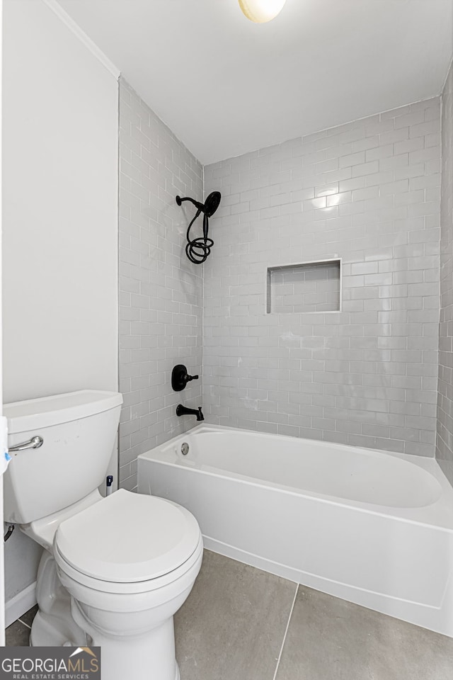 bathroom featuring bathtub / shower combination, tile patterned flooring, and toilet