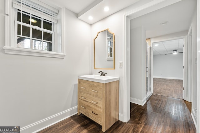 bathroom featuring wood-type flooring, vanity, and ceiling fan