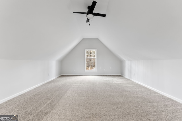 additional living space with carpet flooring, ceiling fan, and lofted ceiling