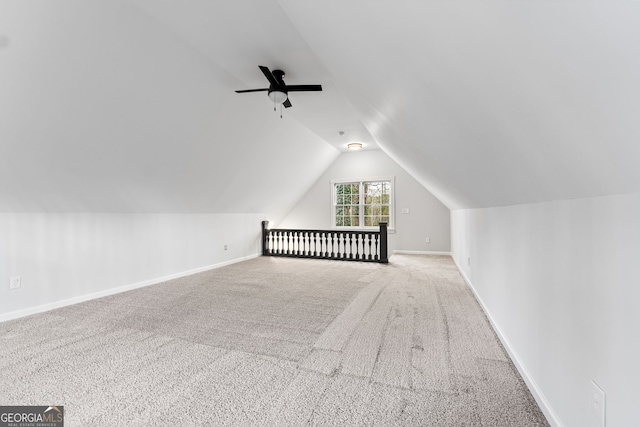 additional living space featuring ceiling fan, light carpet, and vaulted ceiling