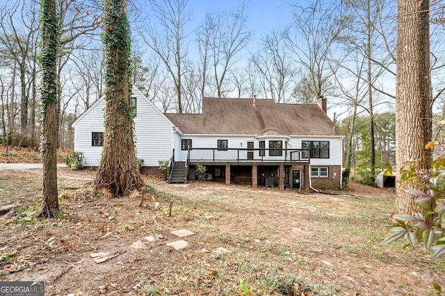 rear view of house featuring a deck