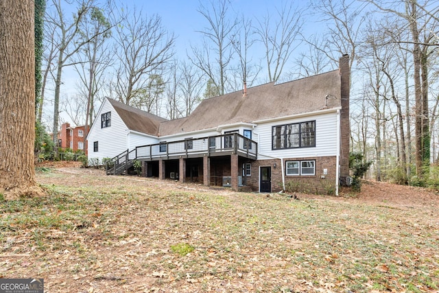 rear view of property with a wooden deck