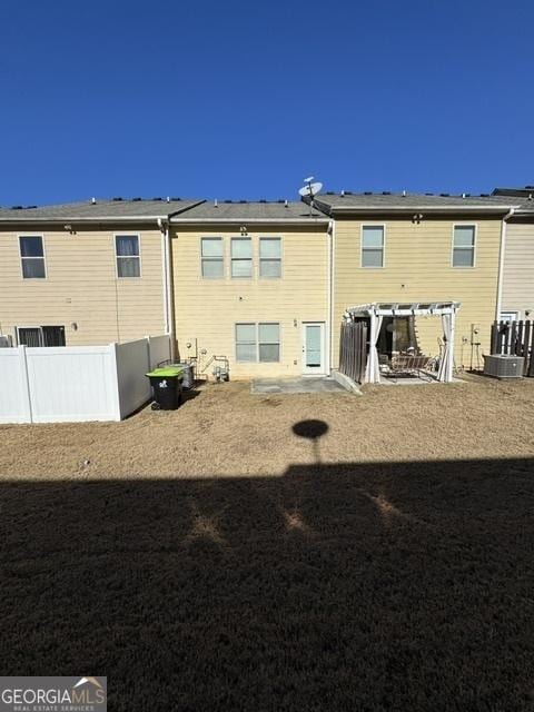 back of property featuring a pergola and cooling unit