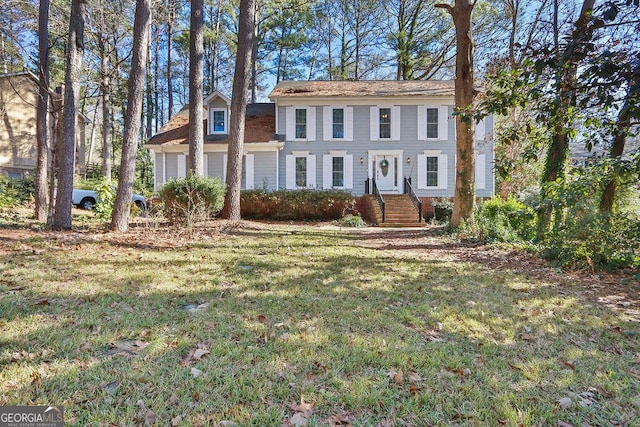 colonial inspired home with a front lawn