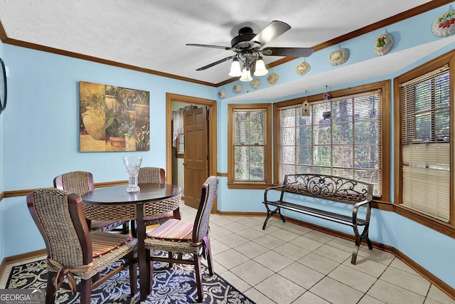 tiled dining room with a textured ceiling, ceiling fan, and ornamental molding