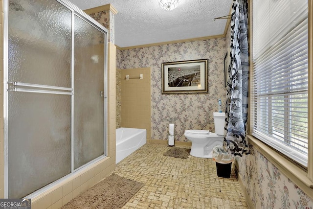 bathroom with a textured ceiling, separate shower and tub, and crown molding