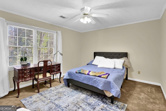 carpeted bedroom with ceiling fan and ornamental molding