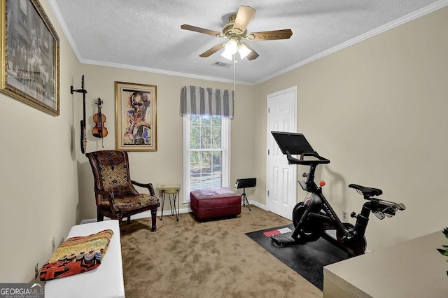 exercise room with carpet, a textured ceiling, ceiling fan, and ornamental molding