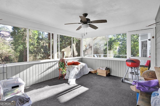 sunroom featuring ceiling fan