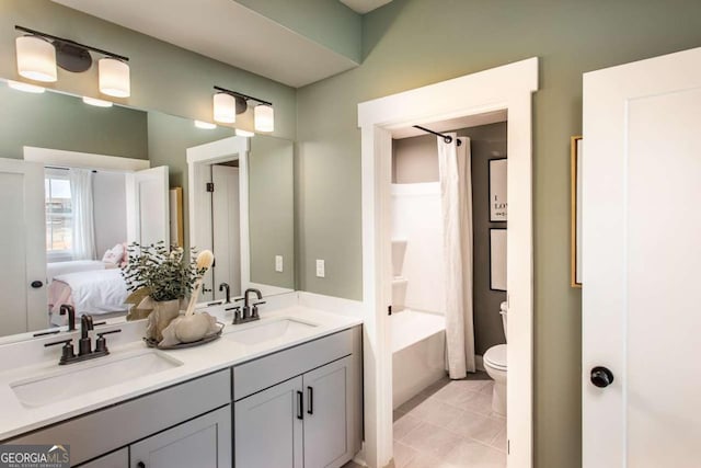 full bathroom featuring tile patterned flooring, shower / tub combo with curtain, vanity, and toilet