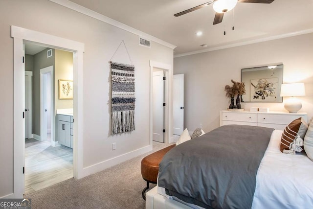 carpeted bedroom with ceiling fan, crown molding, and ensuite bathroom