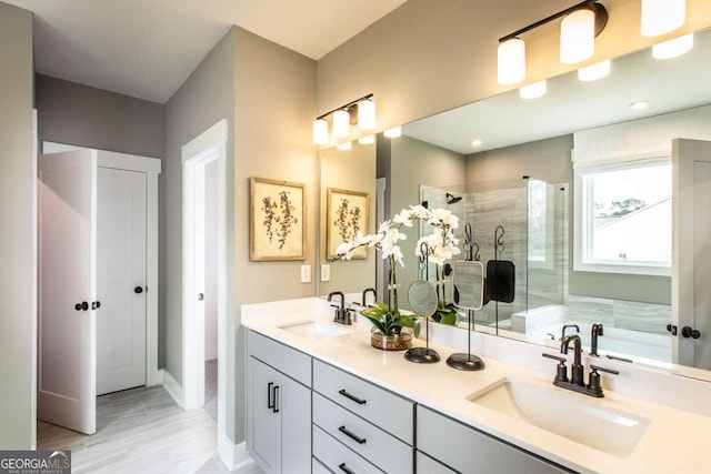 bathroom featuring vanity and independent shower and bath