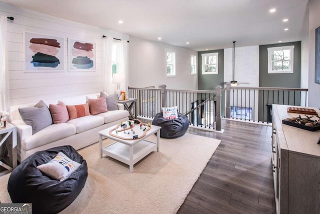 living room featuring hardwood / wood-style floors and ceiling fan