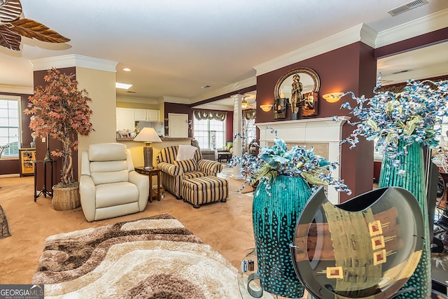 living room featuring light carpet, ceiling fan, and ornamental molding