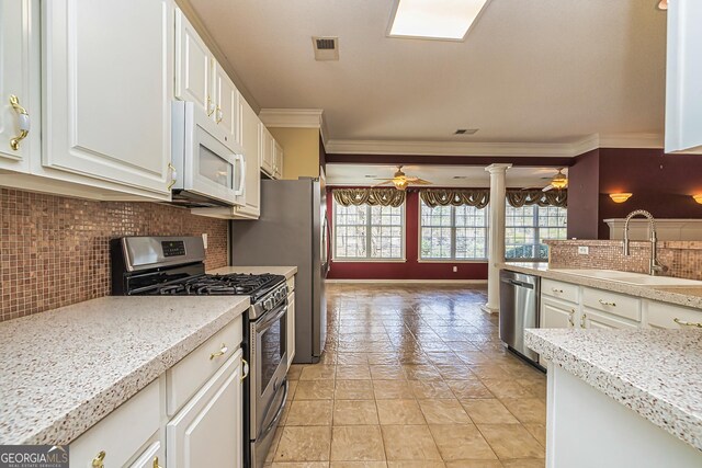 carpeted living room with ceiling fan and crown molding