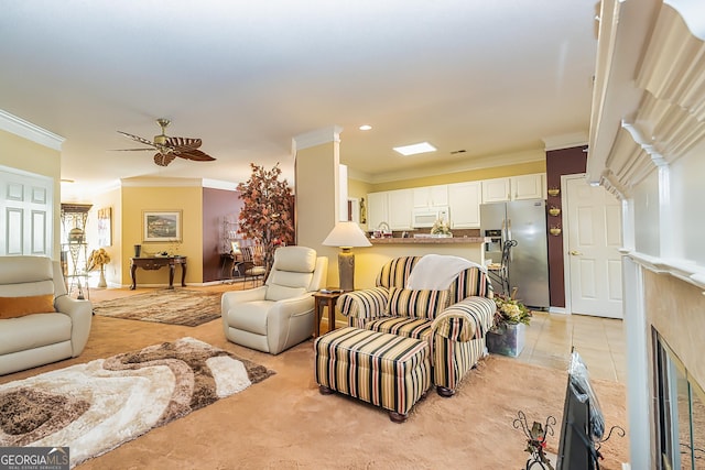 living room featuring ceiling fan, ornamental molding, and light carpet