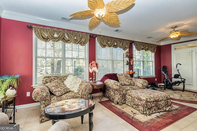 tiled living room with ceiling fan and crown molding