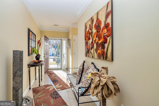 hall featuring ornamental molding and light tile patterned floors