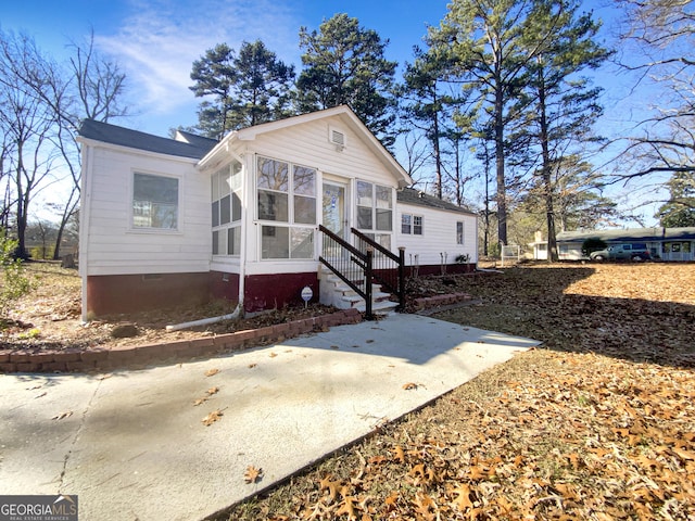 view of front of property featuring a sunroom