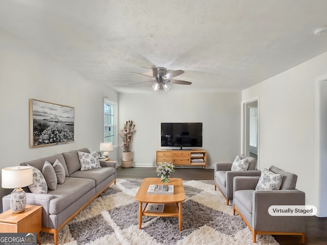 living room with ceiling fan and hardwood / wood-style flooring