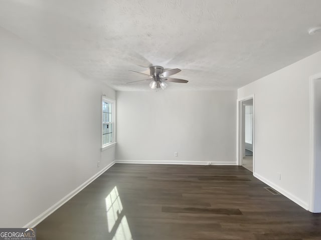 unfurnished room with ceiling fan and dark wood-type flooring