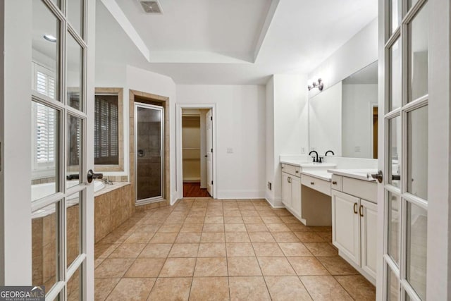 bathroom with tile patterned floors, separate shower and tub, french doors, and vanity