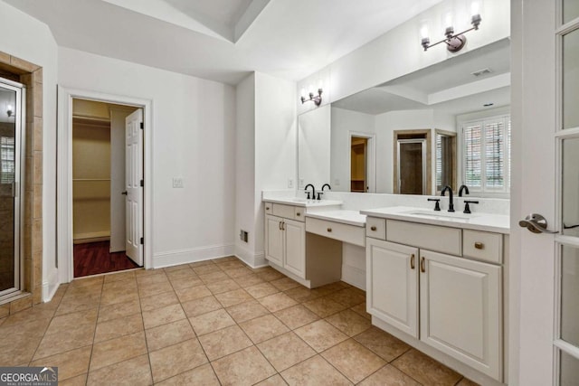 bathroom with a raised ceiling, tile patterned flooring, vanity, and an enclosed shower